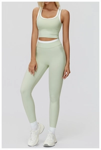 Detail of high-stretch light green yoga set featuring ribbed fabric and racerback sports bra