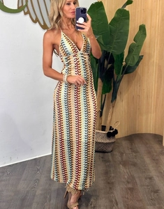 Detail of bohemian crochet maxi dress with colorful wave patterns and halter neckline