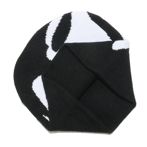Close-up of black and white patterned knit beanie showing warm winter fabric texture