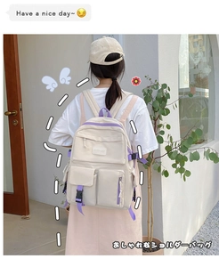 Detail of off-white multi-pocket backpack with purple straps shown on model