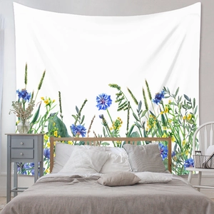 Detail of floral tapestry hanging over bedroom bed with watercolor wildflowers design