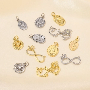 Rose flower and infinity symbol charms in gold and silver finish on soft fabric