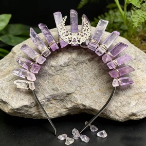 Handmade lavender crystal crown with silver moon ornament on a natural rock background