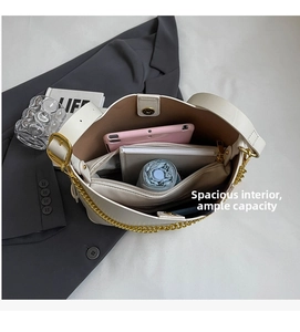 Detail of white leather bucket bag interior showing large capacity for tablet and items