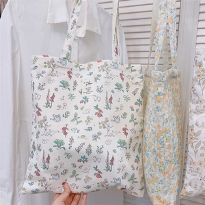 Detailed shot of canvas tote bags featuring colorful animal prints and yellow floral patterns