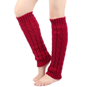 Close-up of red cable knit leg warmers showing detailed texture and soft fabric