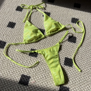 Close-up of glittery neon green bikini fabric showing shiny sparkles and texture