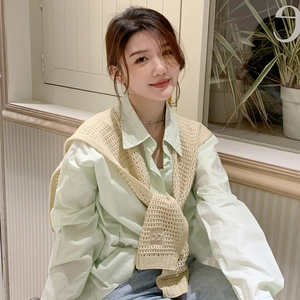 Elegant beige knitted shawl over a light green shirt, ideal for stylish layering
