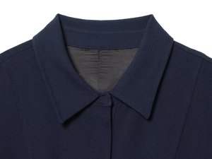 Detailed macro view of navy blue shirt collar with high-quality herringbone lining