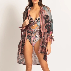 Close-up of tropical floral print swimsuit set featuring cut-out detail and long sleeve cover-up