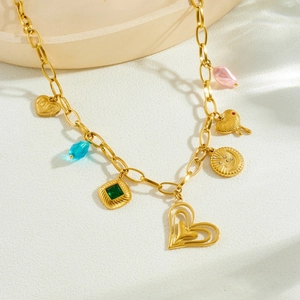 Gold layered heart necklace with emerald green stone and star moon charms for women