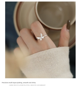 Close-up of S925 silver butterfly ring showing fine textured wings and plating