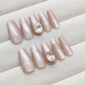 Cat eye press-on nails in pale pink with rhinestones and long trapezoid shape