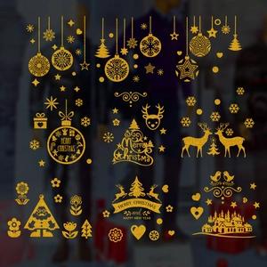 Macro shot of gold glitter Christmas window stickers with Santa, reindeer and snowflakes