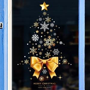 Detail showing golden Christmas tree window sticker with snowflakes and festive bow