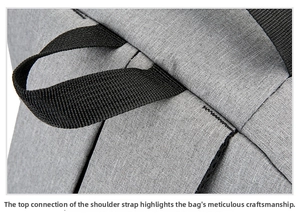 Close-up of reinforced stitching on the gray laptop backpack shoulder strap connector