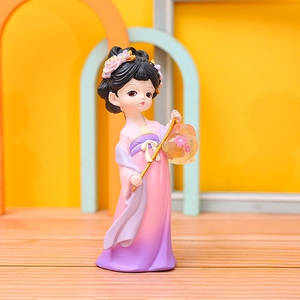 Ancient style doll figure in pink and purple hanfu holding a lantern on wooden floor