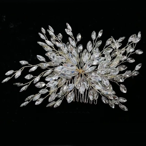 Macro shot of silver bridal hair comb with marquise crystals on black background