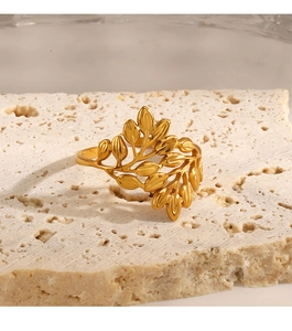 Macro shot of gold leaf-shaped ring showing intricate vein textures on stone base