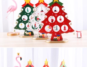 Detail view of miniature wooden Christmas tree desk ornaments with painted bells and train