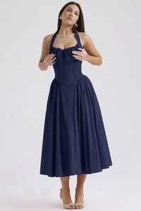 Detail of navy blue halter dress featuring a drawstring ruched chest and slim fit waist