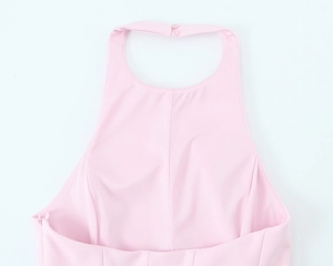 Close-up of back neck button closure on a pink halter top with smooth fabric texture
