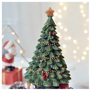 Detailed close-up of a Christmas tree music box with festive red bows and golden star