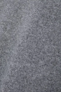 Close-up of dark grey high-quality wool fabric texture with soft knit ruffles
