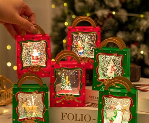 Detail of Christmas water globe lantern showing Santa and reindeer inside a festive gift box