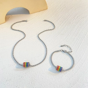 Detailed macro view of rainbow bead pendant on twisted chain and snake chain bracelet set