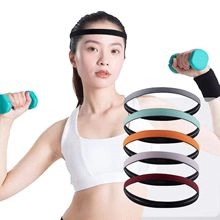 Detail showing various colors of elastic non-slip sports headbands on a model