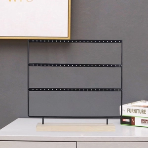 Three-tier black metal earring display stand with a natural solid wood base for jewelry storage