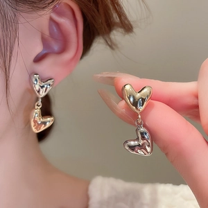 Polished metallic double heart dangle earrings with minimalist mirrored gold finish
