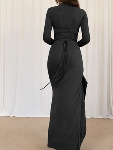 Close-up of elegant back criss-cross straps on a black slim fit maxi dress