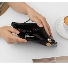 Close-up view showing the internal compartments of a black bamboo pattern clutch bag.