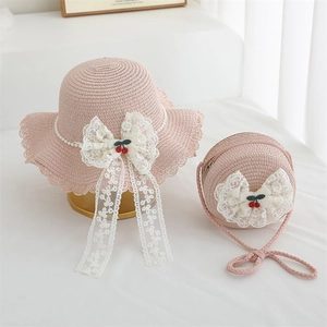 Pink straw sun hat and matching crossbody bag set with white lace bow and cherry accents