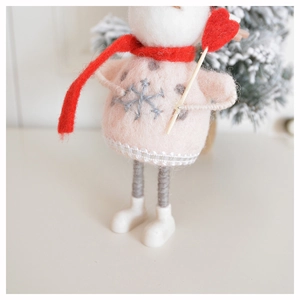 Close-up of handmade wool felt snowman ornament on a festive Christmas tree