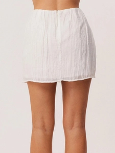 Detail view of white mini skirt with crinkle texture and back invisible zipper closure