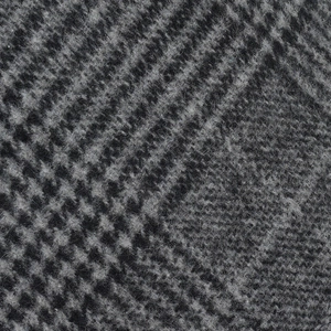 Macro detail of the grey checkered wool fabric on the winter flat cap for men