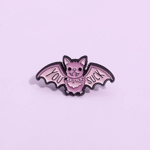 Halloween pink bat enamel brooch with You Suck text on a matching purple background
