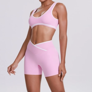 Close-up of pink yoga set showing the cross high waist design and white edge trim details