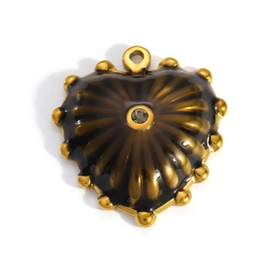 Macro view of a 18k gold heart charm with brown enamel and central rhinestone