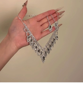 Detail shot of silver tassel necklace and earring set with shimmering crystals