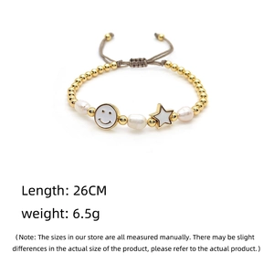 Detail of adjustable pearl beaded bracelet with star and smiley charms, 26cm length