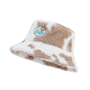 Cute cow pattern plush bucket hat with soft faux fur and Sea Breeze shell patch