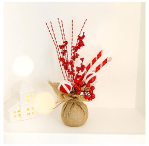Macro view of Christmas red berry ornament with burlap base and festive ornaments