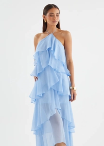Detailed view of sky blue tiered ruffles on a flowing chiffon halter neck dress