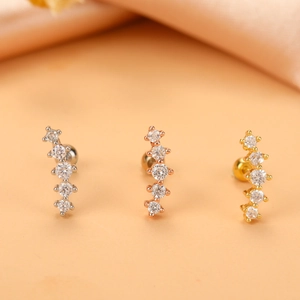 Three surgical steel cartilage earrings with curved cubic zirconia studs in silver, gold, and rose gold
