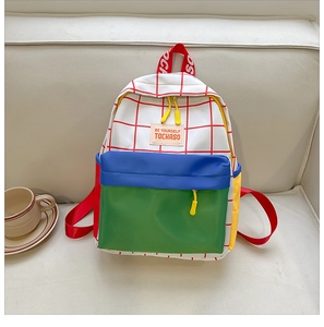 Detail of color-block canvas kids backpack with plaid pattern and vibrant accents