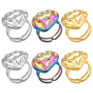 Three pairs of heart rings in gold silver and rainbow finishes with molten metal textures